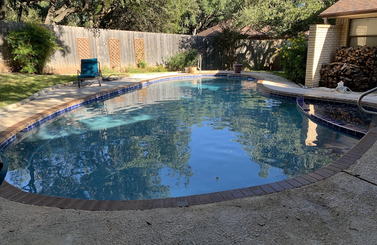 Dark finished pool with spa and tile accents